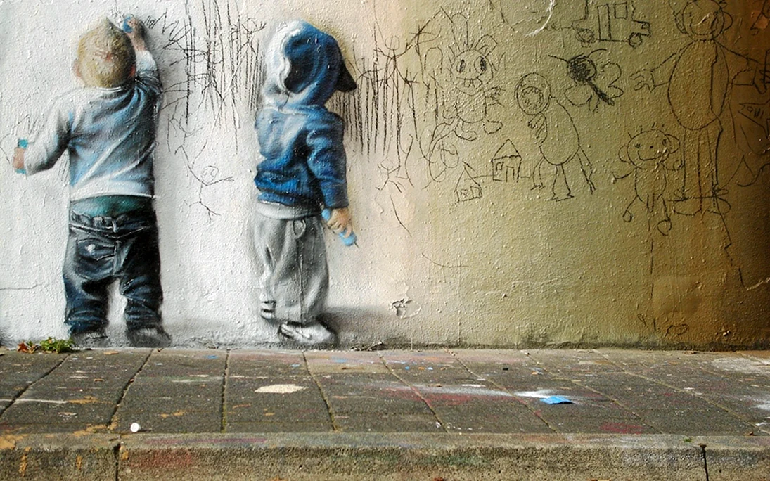Мальчик рисует на стене